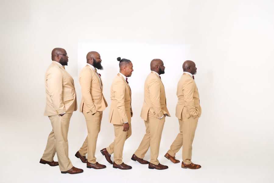 The group walking in profile, studio 2026